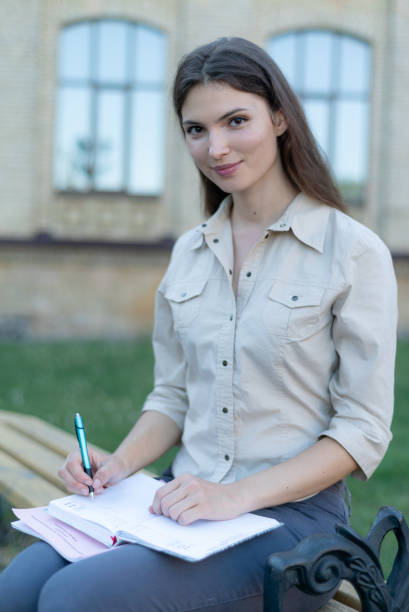 istock Young beautiful girl student in shirt 1266223730