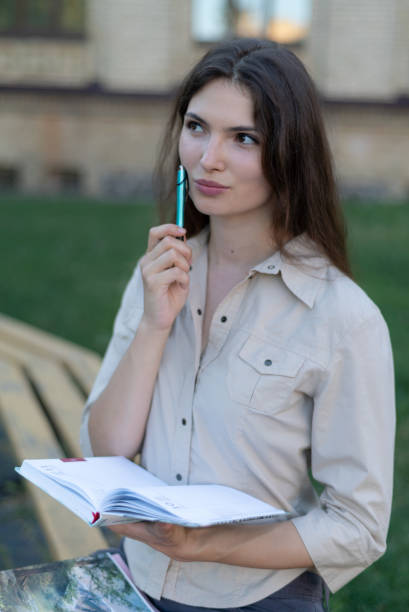 istock Young girl student with pen 1266223838