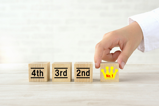 Child's hand and wooden blocks with ranking number
