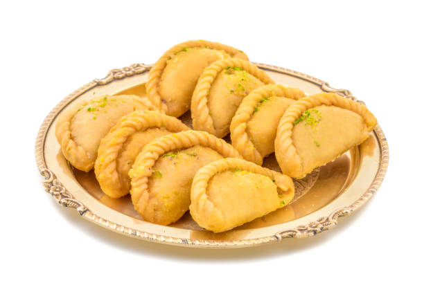 Gujiya or Gujia is a indian sweet food Gujiya or Gujia is a indian sweet dumpling made with suji, Maida or wheat flour and stuffed with khoya. It is common in North India, particularly in Bihar, Uttar Pradesh, Madhya Pradesh or Rajasthan mithai stock pictures, royalty-free photos & images