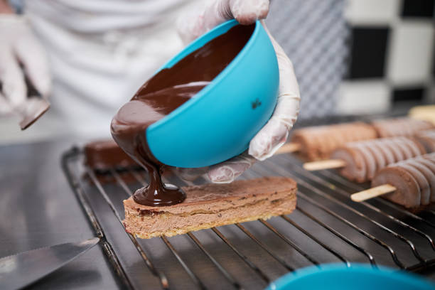 istock Chef icing ice cream cookies with melted chocolate 1266230707