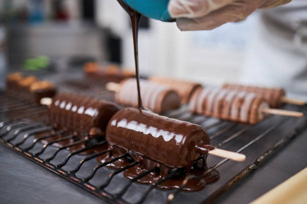 istock Confectioner icing ice cream with chocolate 1266230801