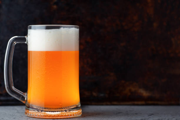 istock Glass mug of wheat unfiltered beer on a rusty background copy space 1266235734