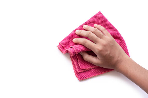 Duster Closeup hand holding pink duster microfiber cloth for cleaning isolated on white background with clipping path. microfiber stock pictures, royalty-free photos & images