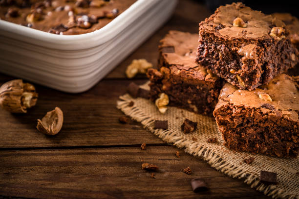 istock Homemade chocolate brownie on a rustic wooden table 1266242545