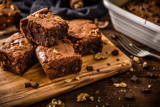 hausgemachte schokolade brownie auf einem rustikalen holztisch - brownie baked bakery brown stock-fotos und bilder