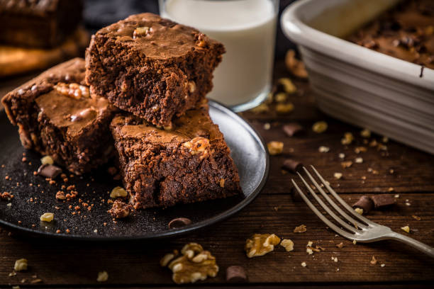 istock Homemade chocolate brownie on a rustic wooden table 1266242558