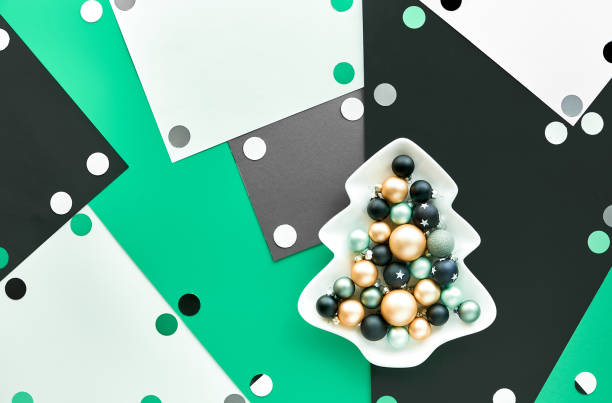 istock Abstract Christmas background with baubles in plate with Xmas tree silhouette on multicolor layered paper background. 1266245933