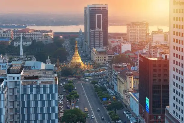 01/22/2020 Yangon, Myanmar (Burma), Aerial shot, view from the drone on the downtovn of Yangon with Shwedagon Pagoda and street traffic at sunset pop colors. Yangon - the ancient capital of Burma