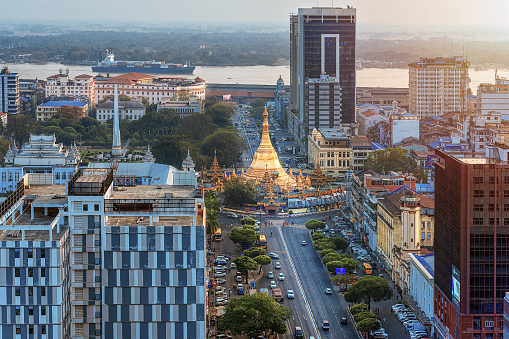 01/22/2020 Yangon, Myanmar (Burma), Aerial shot, view from the drone on the downtovn of Yangon with Shwedagon Pagoda and street traffic at sunset pop colors. Yangon - the ancient capital of Burma