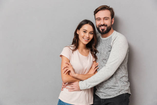 istock Portrait of a smiling young couple hugging 1266248559