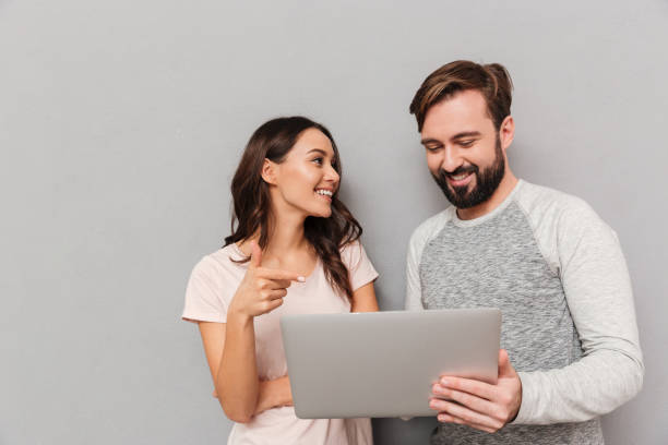 istock Portrait of a happy young couple using laptop computer 1266248752