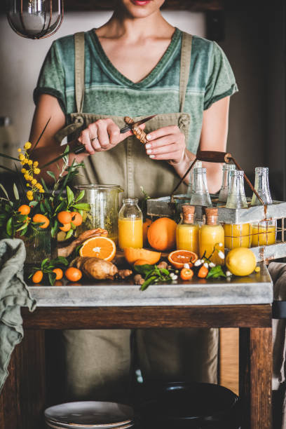 istock Young woman making fruit immune boosting drink to resist virus 1266248980