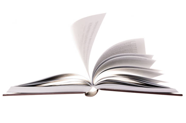 istock Open hardcover book with flying pages, isolated on white background. Sel 1266250006