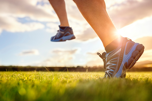 Outdoor cross-country running in early sunrise concept for exercising, fitness and healthy lifestyle