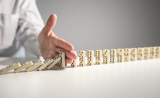 Stopping the domino effect concept for business solution, strategy and successful intervention