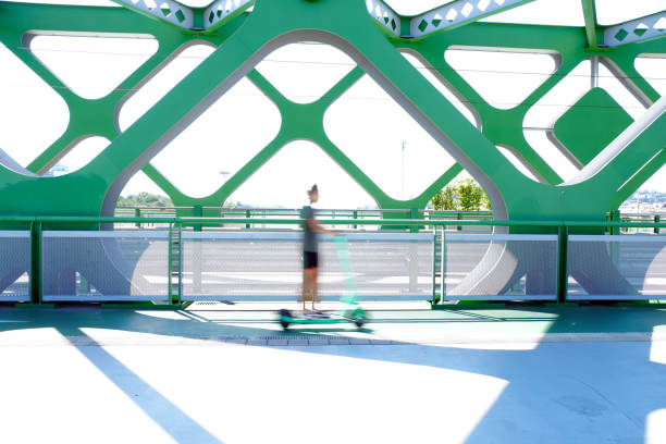 istock A person riding an e-scooter on the bridge. 1266251227