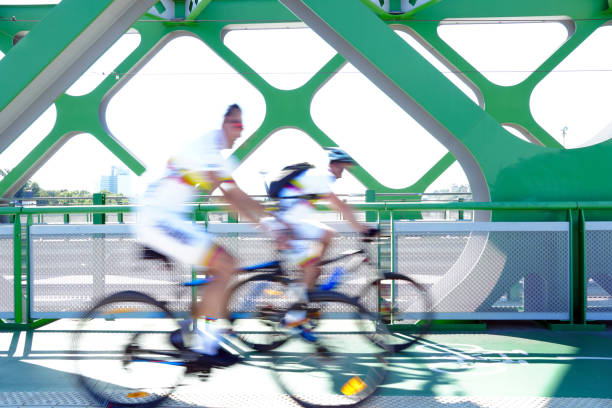 istock Two persons riding a bicycle on the bridge. 1266251235