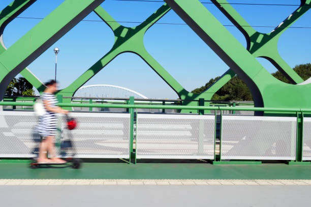 istock A person riding an e-scooter on the bridge. 1266251268