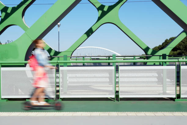 istock A person riding an e-scooter on the bridge. 1266251356