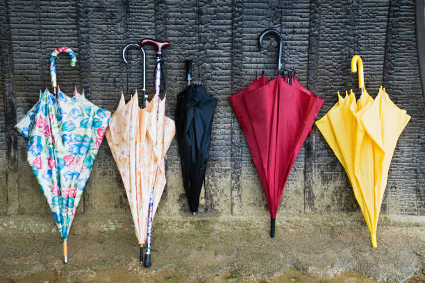 istock Colorful Umbrellas Leaning Against a Wall 1266256351