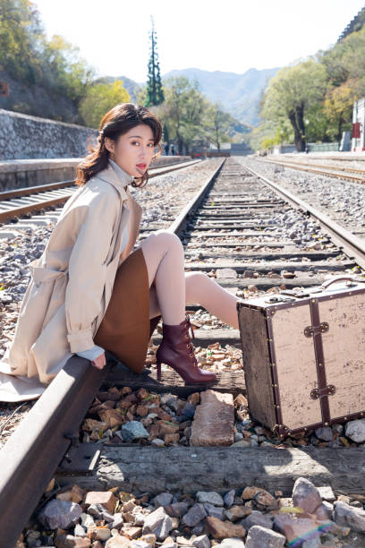 istock Young women sat on railroad tracks 1266257478