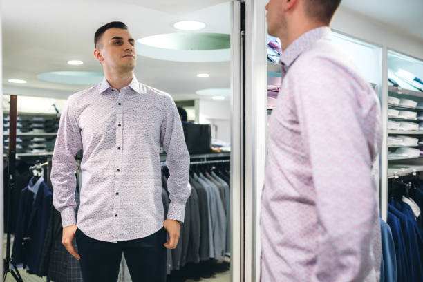 istock Man trying shirt in a store 1266257947
