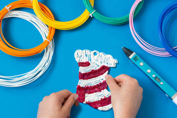 istock Child makes toys for Christmas tree with 3D pen. Step 5 1266259459