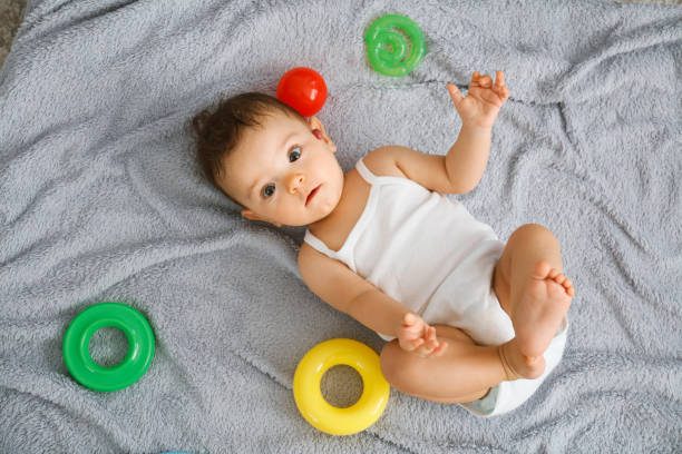 istock Carefree baby boy crawling on floor 1266259503
