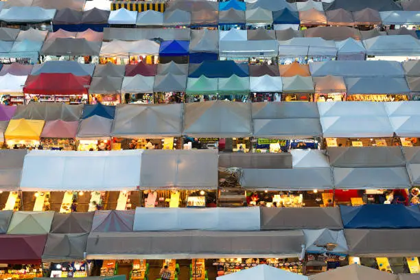 Photo of 01/02/2020 Bangkok, Thailand, Top view of Train Night Market Ratchada (Talad Rot Fai) flea market with plenty of shops with colorful canvas and amazing pattern of roofs near MRT line at night time in Bangkok