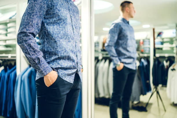 istock Man trying shirt in a store 1266259760