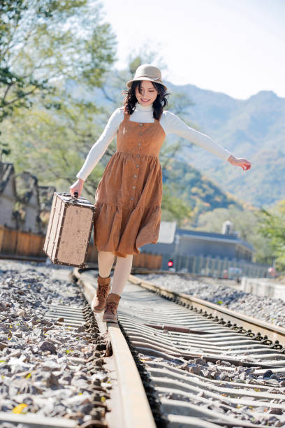 istock Young women walk on the railway tracks 1266260002