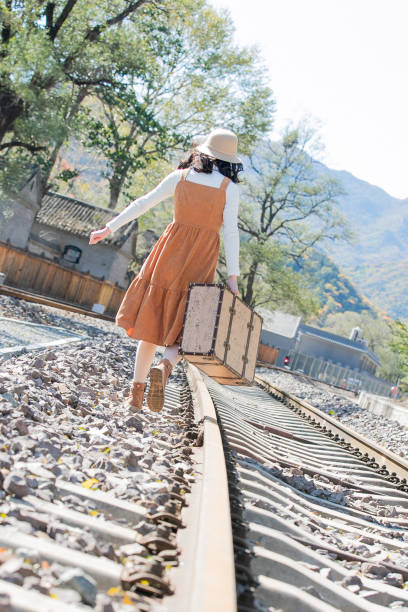 istock Young women walk on the railway tracks 1266260025