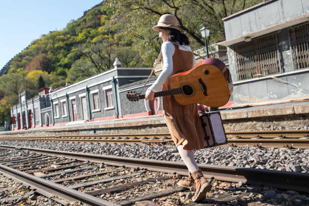 istock Young women walk on the railway tracks 1266260051