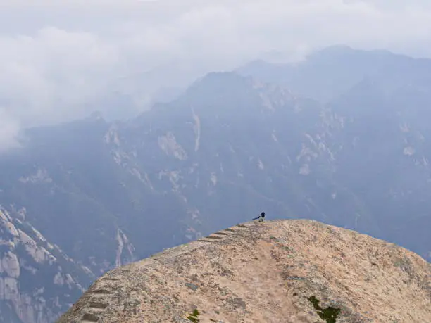 Photo of Huashan Mountain near Xian City. The Most dangerous Trail and Crowned People in China. Mount Hua is one of the Five Great Mountains of China in Huayin City, Shaanxi Province, China, 18th October 2018