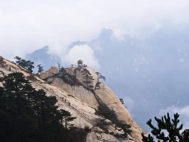 Photo of Huashan Mountain near Xian City. The Most dangerous Trail and Crowned People in China. Mount Hua is one of the Five Great Mountains of China in Huayin City, Shaanxi Province, China, 18th October 2018