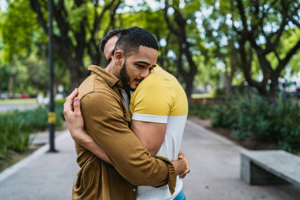istock Gay couple embracing in park 1266262194
