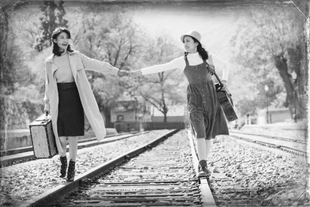 istock Young girlfriends go hand in hand on the rail 1266268141
