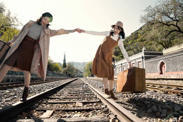 istock Young girlfriends go hand in hand on the rail 1266268195