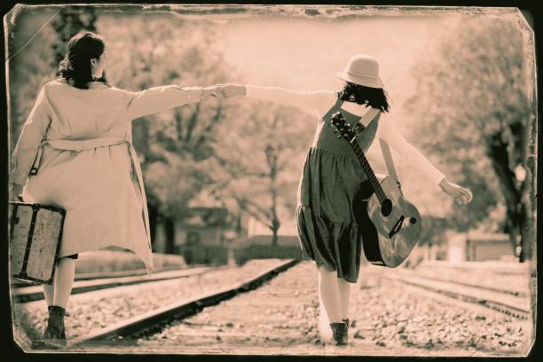 Young girlfriends go hand in hand on the rail