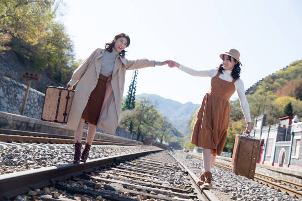 istock Young girlfriends go hand in hand on the rail 1266268283