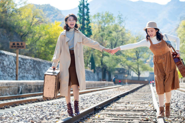 istock Young girlfriends go hand in hand on the rail 1266268285