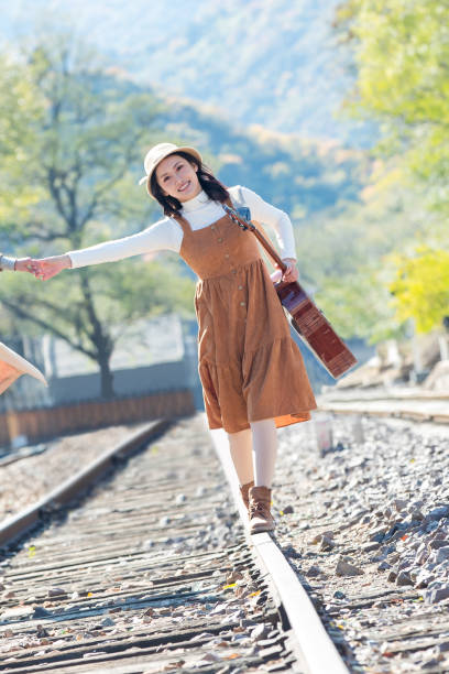 istock Young girlfriends go hand in hand on the rail 1266268290