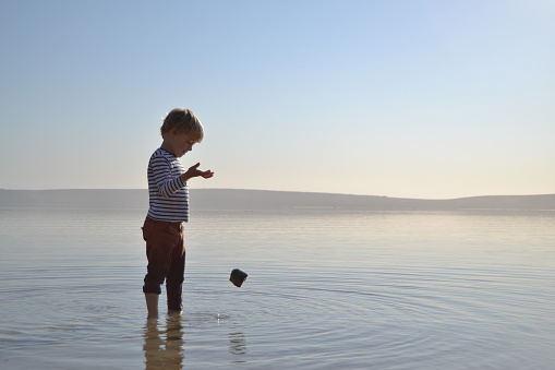 Two little brothers playing on the beach.