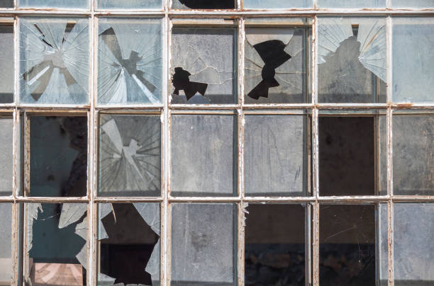 istock Old window frame of industrial building with broken glass 1266271283