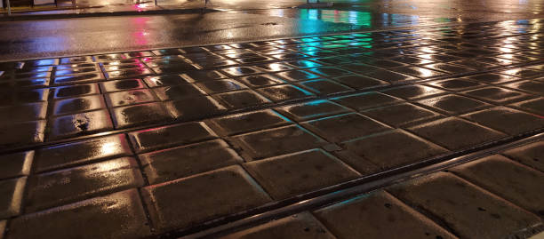 istock pavement wet from the rain with reflective lights in the evening 1266272983