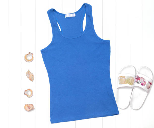 istock Neon blue tank top with seashells and flip flops on white background 1266274431