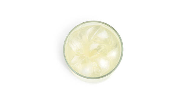 istock Glass with lemon lemonade and ice on a white background. View from the top 1266276978
