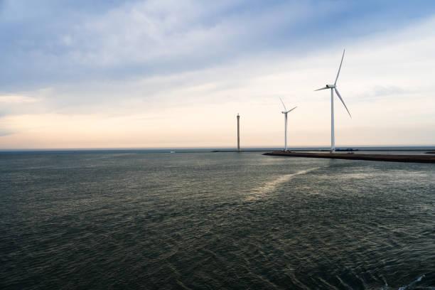 istock Wind farm and the sea waves 1266279208
