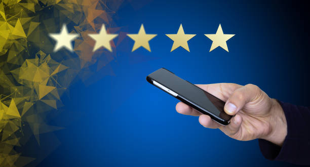 istock Customer service, performance analysis. A man hand using smart phone with icon five star symbol to increase rating of company 1266279220